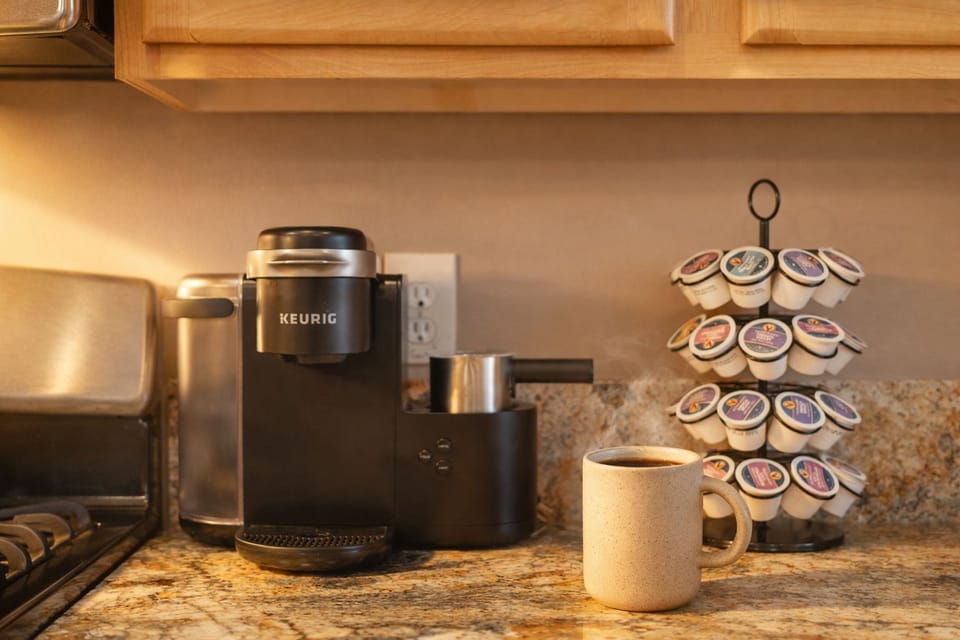 Cozy kitchen coffee station with Keurig, kettle, and pod selection