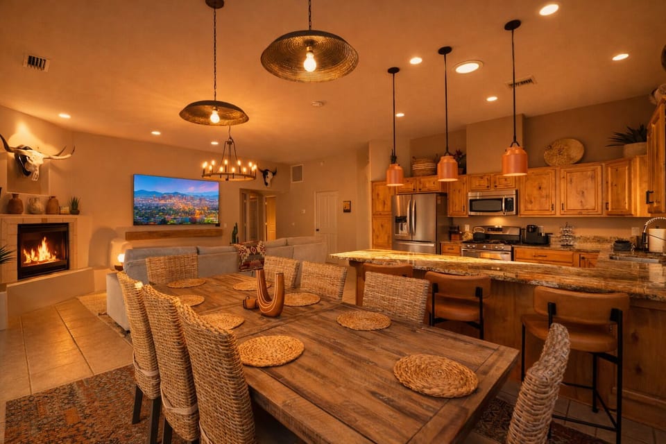Warm open-concept living with fireplace, chef’s kitchen, and large dining area