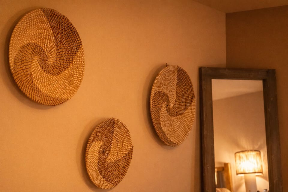Warm, earthy decor with woven wall art and a rustic mirror