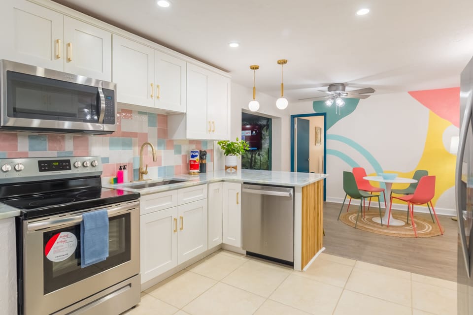 Open concept kitchen with all the utensils, pots, pans, blender, rice maker, toaster, etc you would expect to be able to cook a great meal for your family and friends! 2 dining rooms and bar-top seating can accommodate your entire group!
