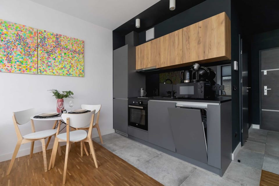 A sleek kitchen with dark cabinets, wooden finishes, and modern appliances, ensuring practicality and style.
