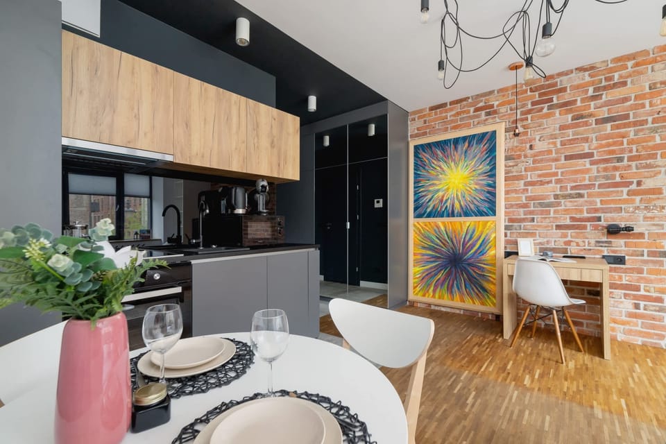 A wide view of the studio’s layout, featuring colorful decor, wooden flooring, and a functional open-plan design.
