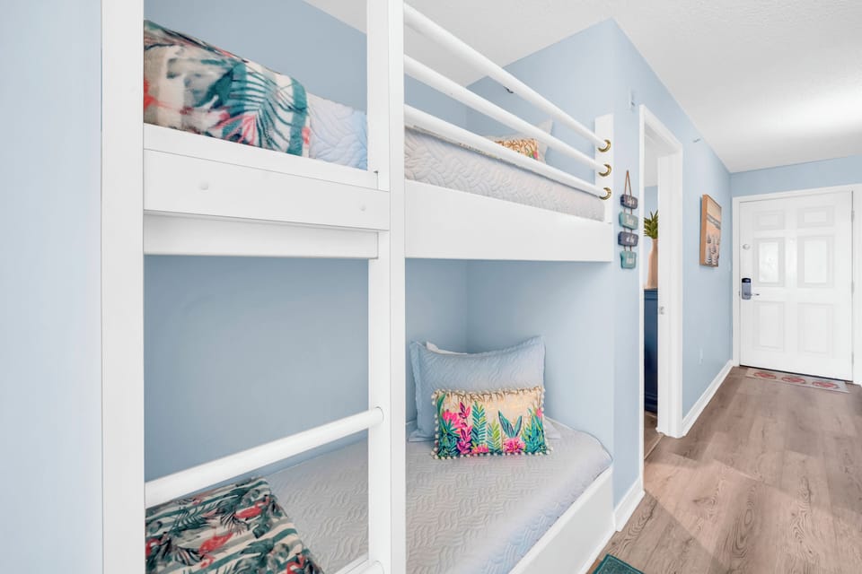 Cozy bunk beds with tropical-themed bedding create the perfect space for your group to rest and recharge together.