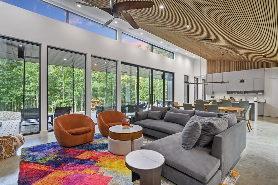 Living Room: Sunlit space with vibrant decor and woodland views for ultimate relaxation!