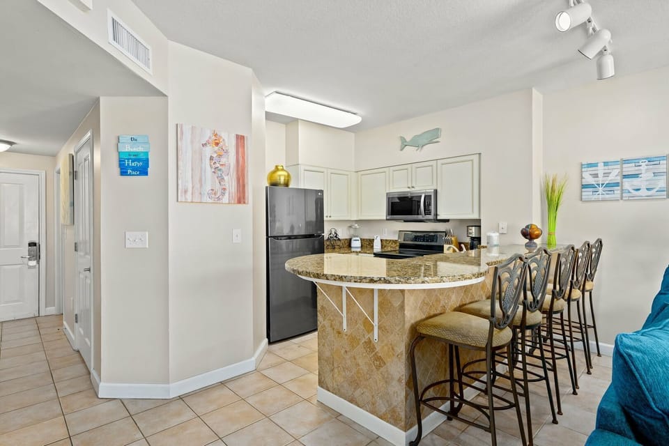 Fully Stocked Kitchen - Bar Seating • Open Layout • Gulf-Front Condo at Shores of Panama Resort