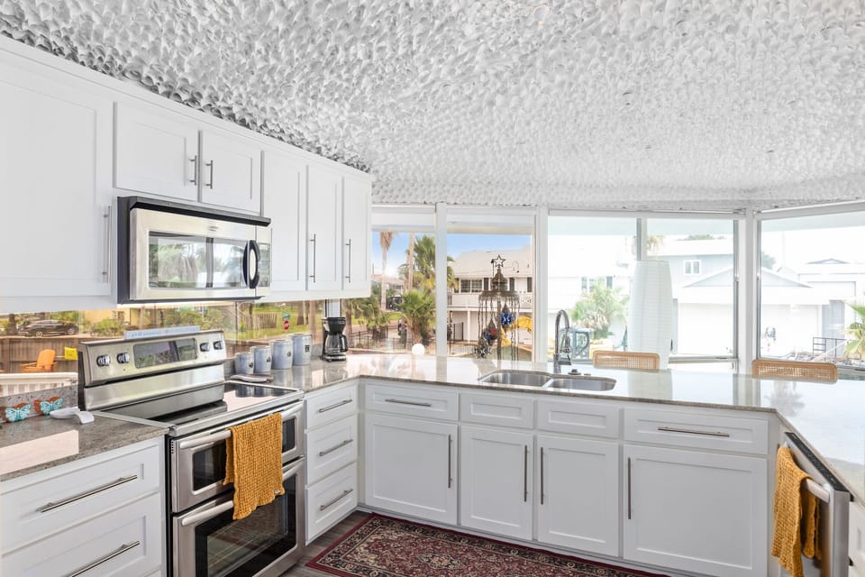 Your fully equipped kitchen features stainless steel appliances and stunning panoramic windows that fill the space with natural light.