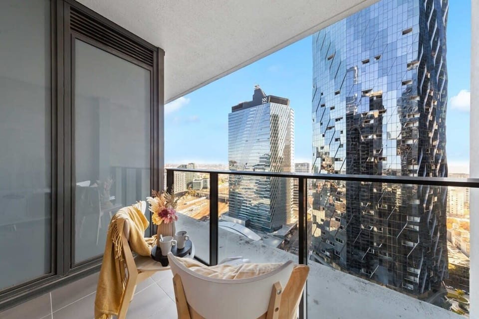 A balcony with city views. *(Chairs on balcony are from the dining area).