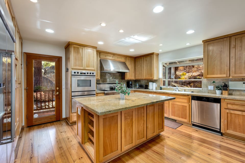 Another view of the fully stocked kitchen with modern appliances.