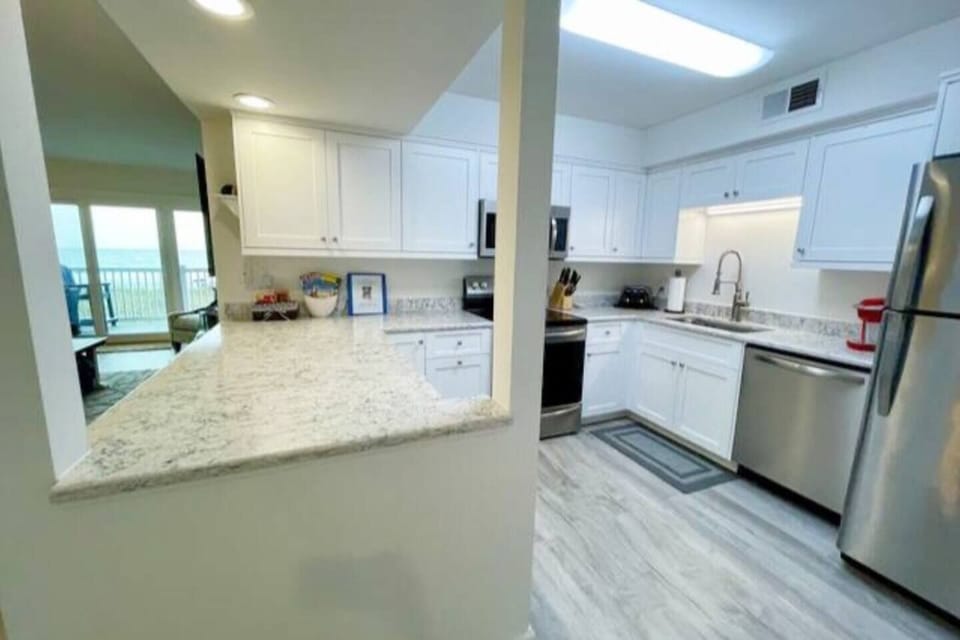 Great kitchen layout with new white cabinets and solid surface countertops.