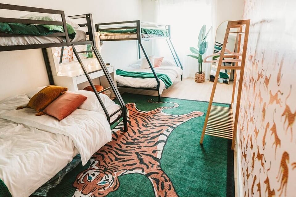 Guest bedroom 3 with two queen (and double) bunk beds, full length mirror, makeup table and stool.