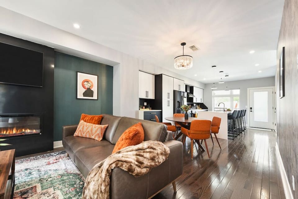 Open-concept living space with modern fireplace, smart TV, and stylish seating — perfect for relaxing after a day out.