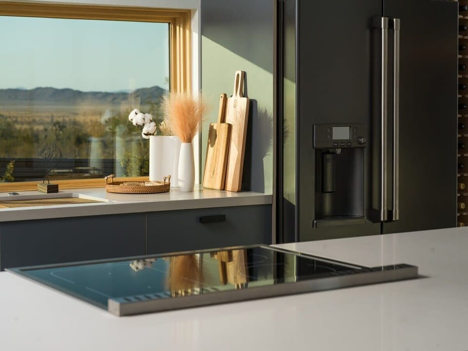 Bertazzoni induction cooktop offers precise and efficient cooking, allowing you to unleash your culinary creativity with ease. The kitchen is also adorned with a Cafe fridge, providing hot water dispensed directly from the door for your convenience.
