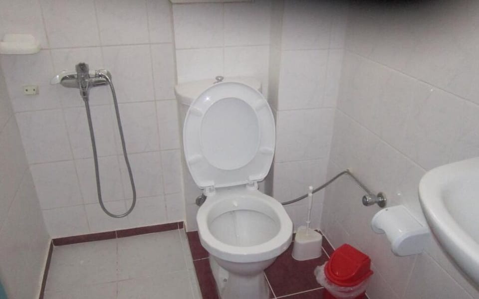 Shower, hair dryer, slippers, towels