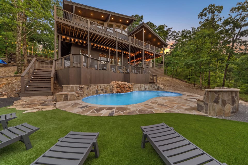Pool with Waterfall, turf area to hang out, upper tanning deck, and more! tucked into the mountainside off the back deck