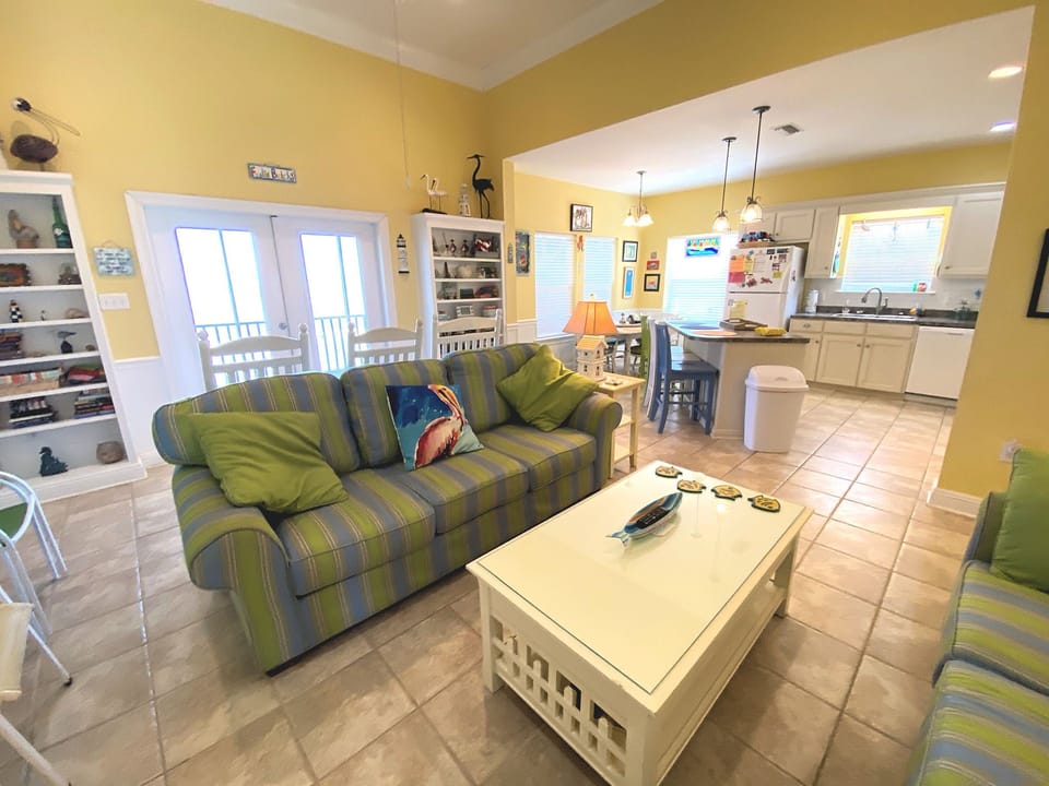 Relax in your bright, cheerful living space where colorful striped seating invites you to unwind after beach days.