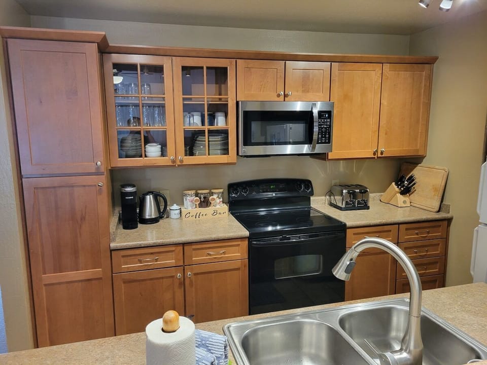 The well-appointed kitchen is on the second level, and has everything you would need to cook up a gourmet meal. Appliances include an Instant Pot, blender, and mixer. We have baking pans and dishes, cooking utensils, pots, and pans.