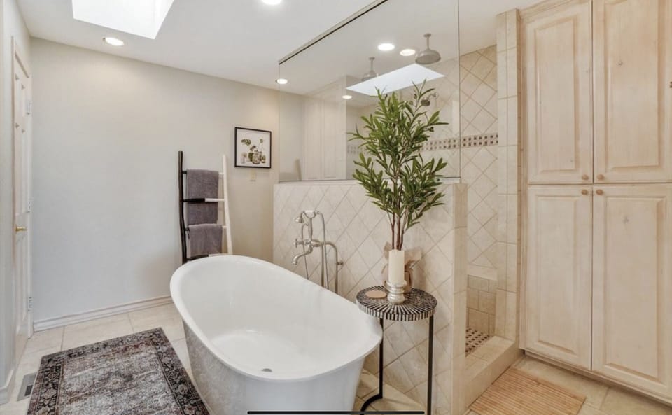 Bathroom off primary bedroom, triple-headed shower, soaking tub, dual sinks