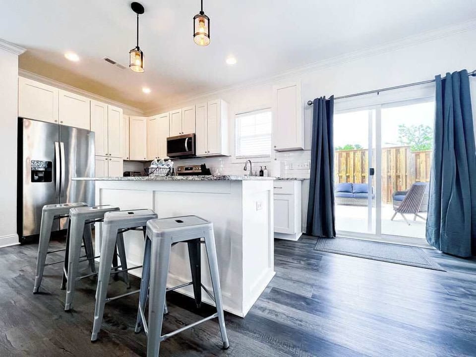 Kitchen with barstools looking out to the patio