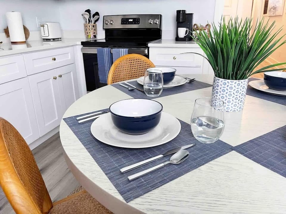 Table for Four! This dining area has enough seating for four comfortably. The table is already made and ready for your next culinary masterpiece.