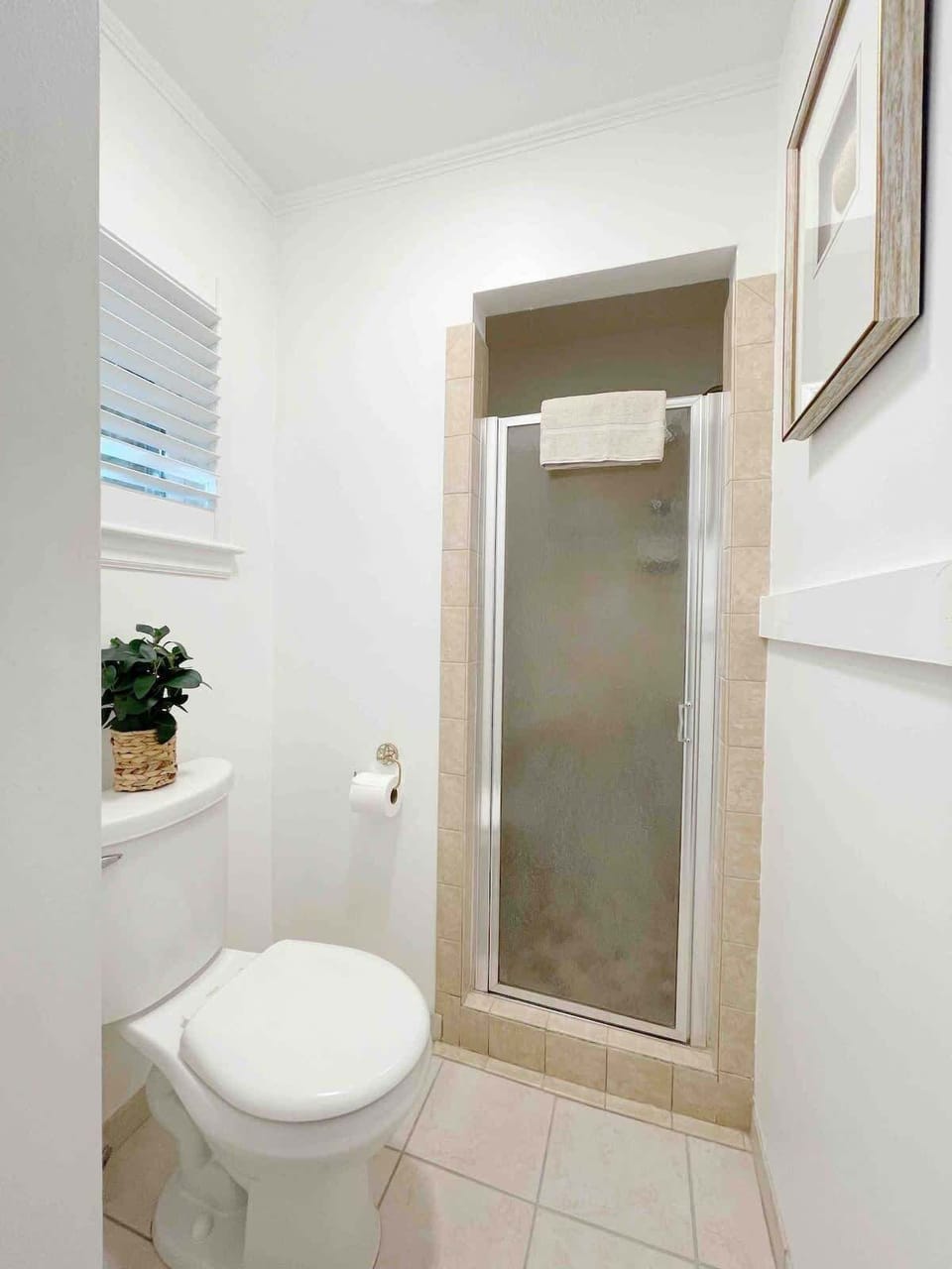 Small but stylish! This bathroom holds a shower, and oversized mirror above the sink, making getting ready a breeze!