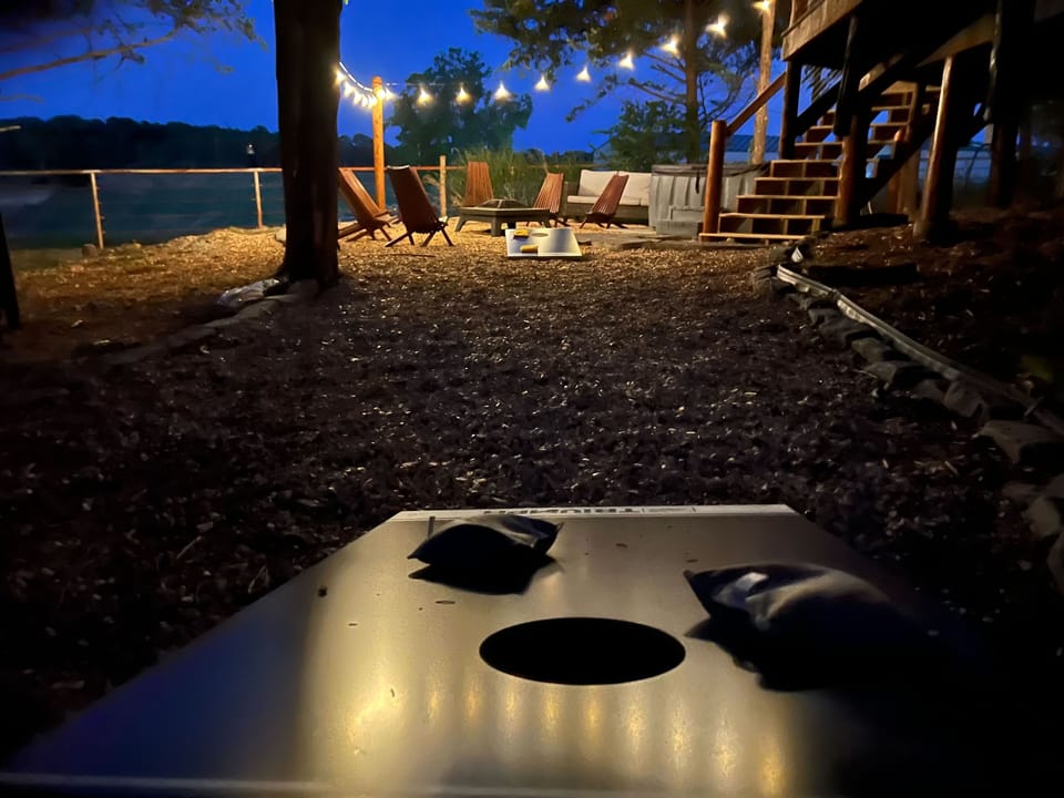 Playing corn hole at night