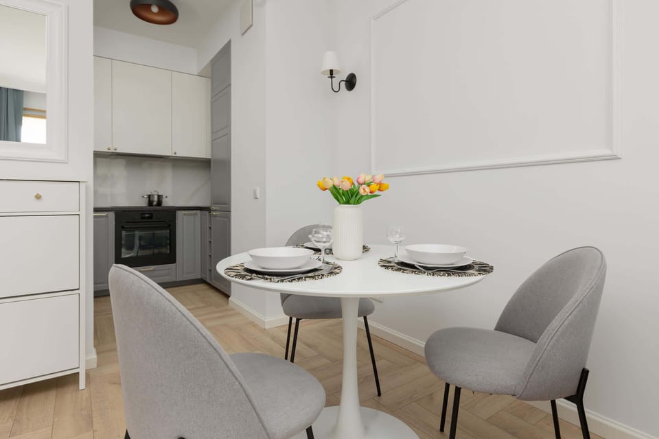 Another view of the dining space connected to the kitchen, emphasizing its bright and airy layout.
