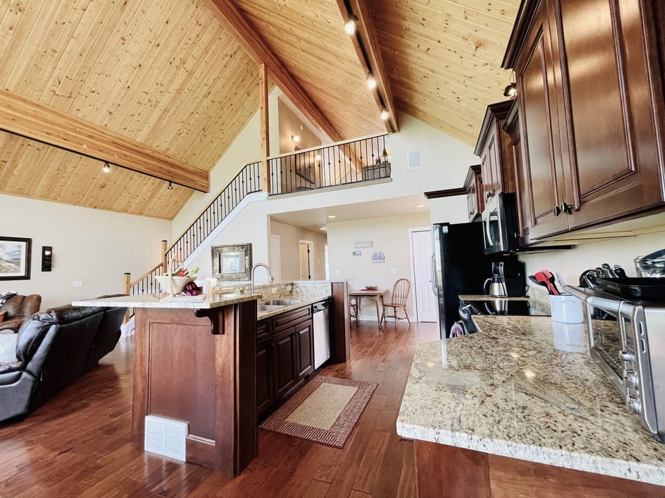 Kitchen with view to stairs leading to loft