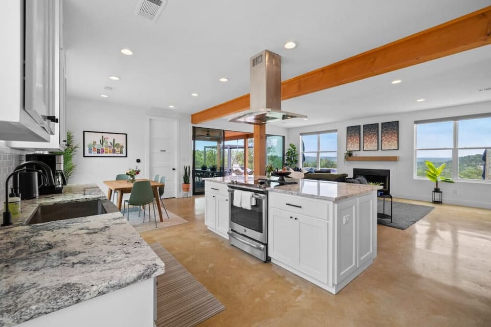 Cooking with a view. The great room is bathed in light and features stunning views out to the valley beyond.