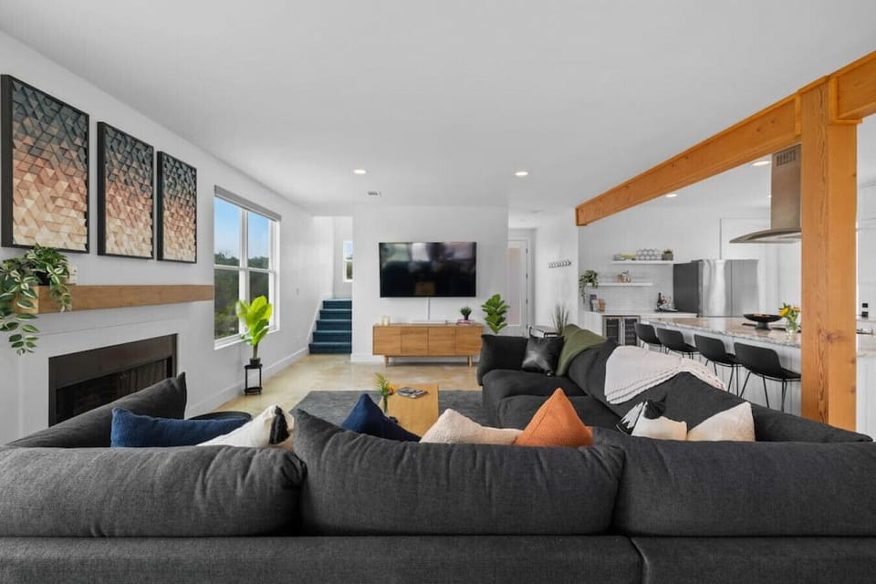 Between the kitchen bar stools and overstuffed couch, there`s ample seating to go around.
