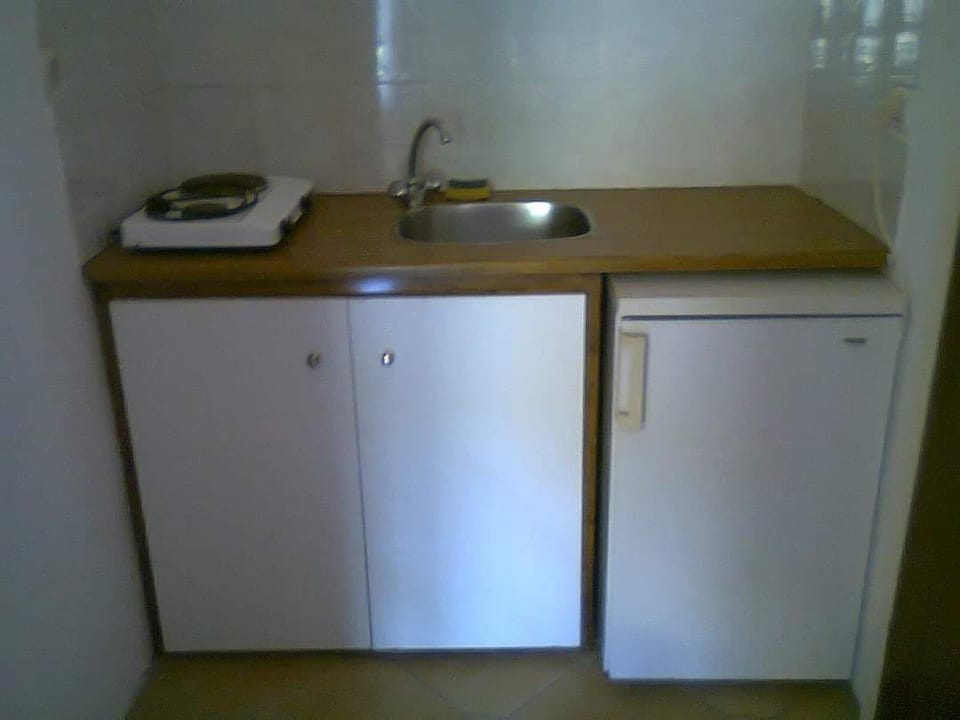 Mini-fridge, stovetop, electric kettle, cookware/dishes/utensils