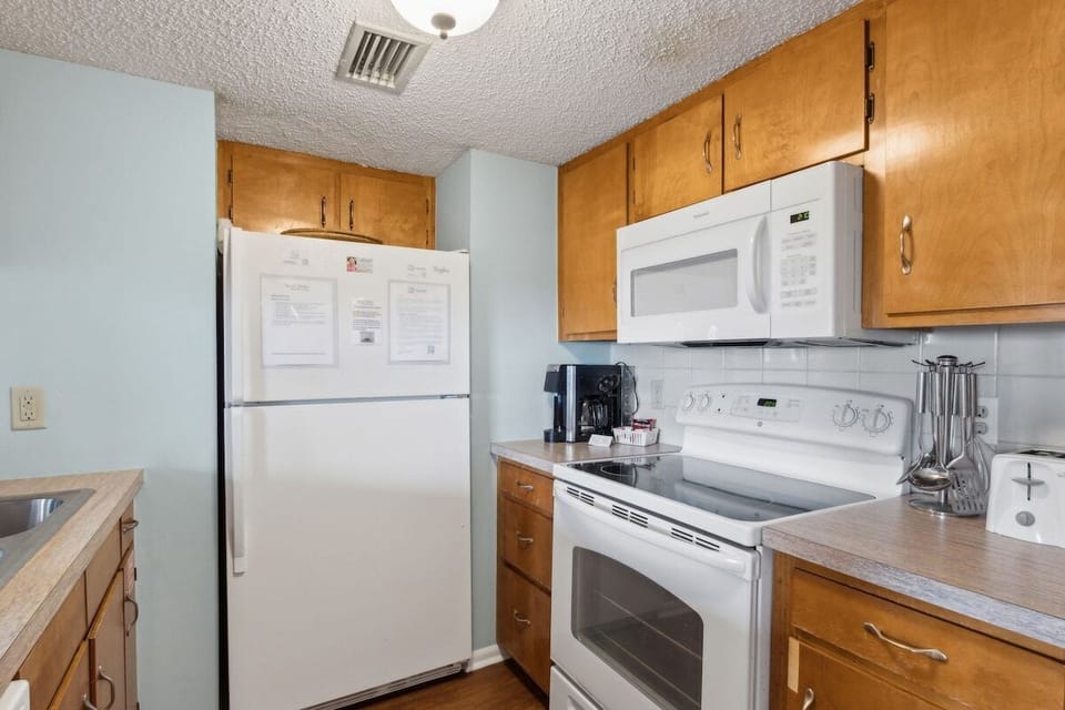Kitchen Range and Microwave at Down by the Sea, a beachfront Sand Dollar Villas vacation condo.