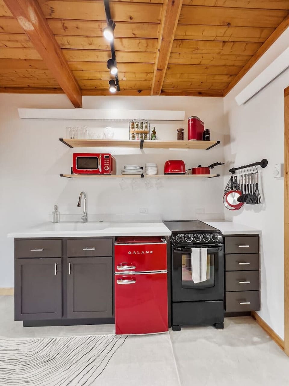 with cups, bowls, plates, mugs, silverware and every cooking utensil you’d need (including barbecue tools)!