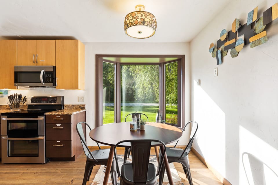 Sunny dining nook w/four-person table by the bay window