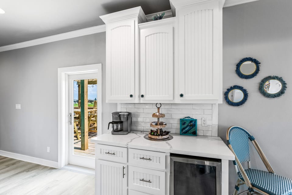 Coffee/wine bar w/wine fridge. Keurig coffee, grnd coffee, creamer, sweetner.