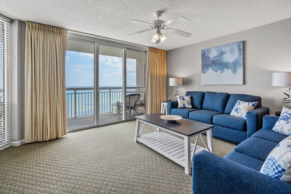 Sliding doors open from the living area to the ocean at Crescent Shores 1807, a 3-bedroom Crescent Beach vacation rental