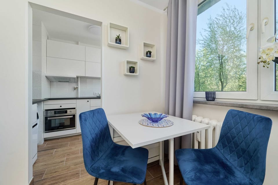 Another perspective of the dining area, showing its integration with the natural light and simple decor.
