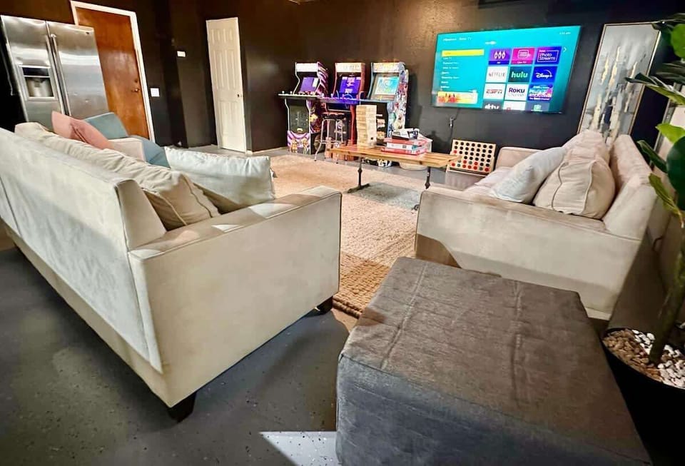 The ultimate entertainment space with a variety of arcade games, board games, and a TV perfect for a movie marathon. Cozy couches and a stylish wood-finish table, and a double-door fridge for your snacks and drinks - perfect room for endless fun.