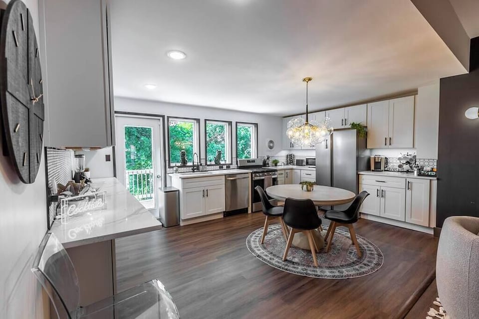 Discover the perfect fusion of openness and functionality in our kitchen area, featuring a spacious design complemented by a round dining table at its center – where culinary delights and shared moments seamlessly come together.