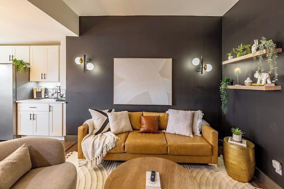 Relax in our spacious living room adorned with a simple yet elegant design, creating a welcoming ambiance for the entire family to gather around a large TV for shared moments of entertainment.