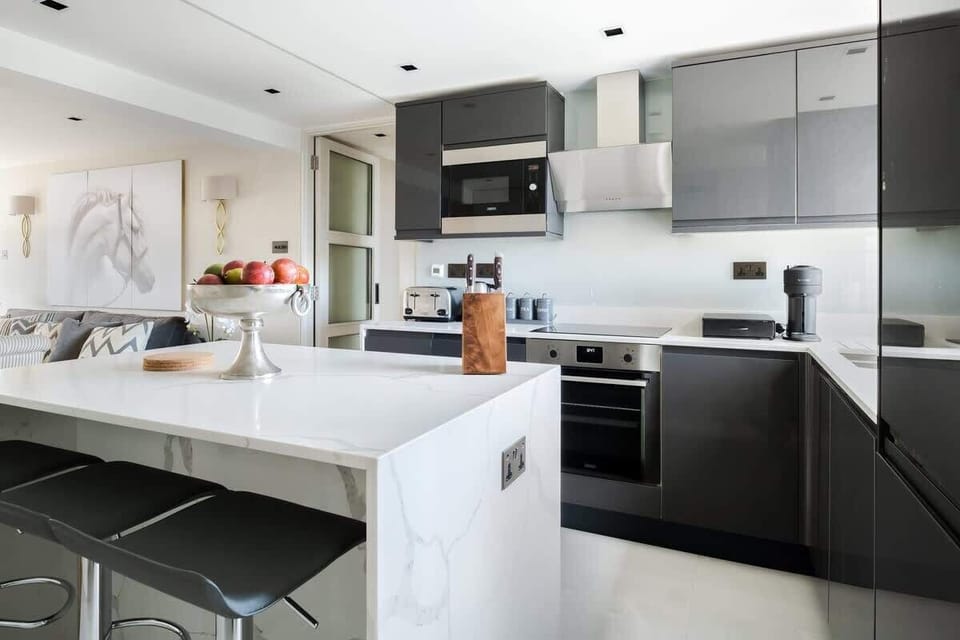 Full Kitchen | Our kitchen is fully equipped with a stylish island and stools. It includes a washing machine, dryer, dishwasher, microwave, Nespresso machine, and a fresh water dispenser.