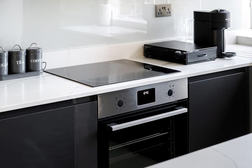 Full Kitchen | Our kitchen is fully equipped with a stylish island and stools. It includes a washing machine, dryer, dishwasher, microwave, Nespresso machine, and a fresh water dispenser.