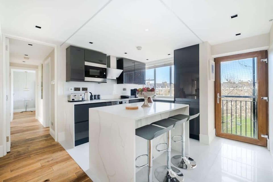 Full Kitchen | Our kitchen is fully equipped with a stylish island and stools. It includes a washing machine, dryer, dishwasher, microwave, Nespresso machine, and a fresh water dispenser.