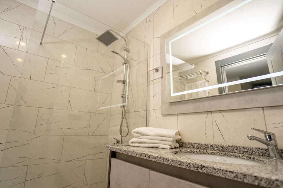 Shower, hair dryer, slippers, towels