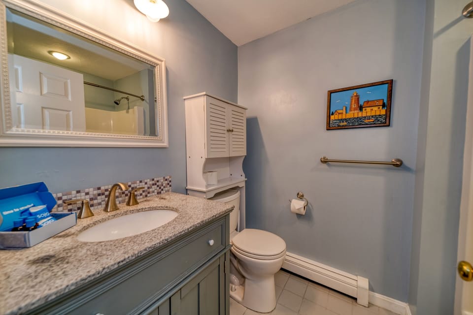 Shared bathroom located in the hallway.