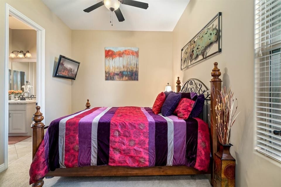 The sixth bedroom has a King size bed, TV and ceiling fan and connects to the third bathroom.