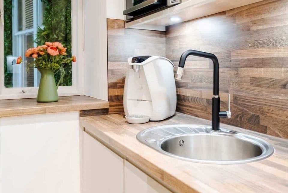 Full Kitchen | A fully equipped kitchen designed for your convenience, featuring everything you need, including a filtered fresh water dispenser (with hot and cold options), an espresso coffee machine, a dishwasher, and a washing machine/dryer