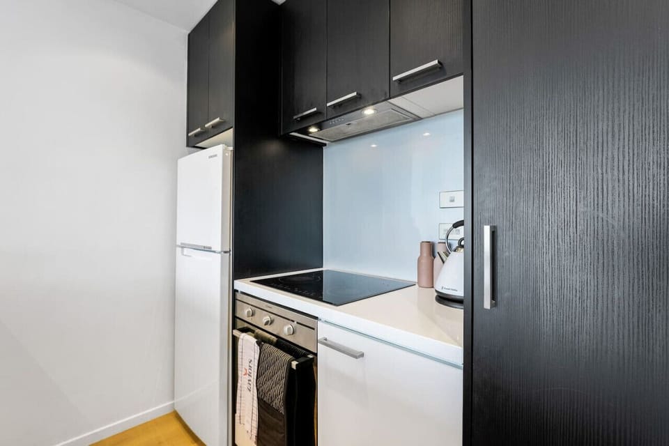 The kitchen is nicely laid out with the appliances on one side and prep space is on the other side.