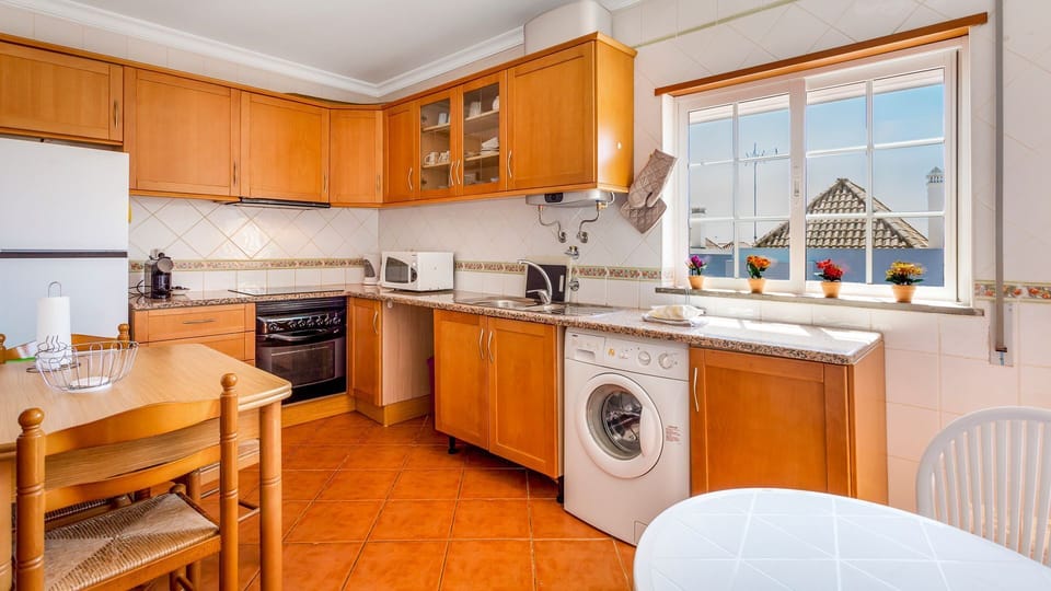 Our kitchen counts with high-quality appliances like a microwave, refrigerator, washing machine, kettle, and coffee maker #practical #airbnbpt