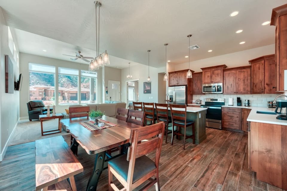 The open floor plan seamlessly connects the living and dining areas, offering unobstructed views through the oversize windows.