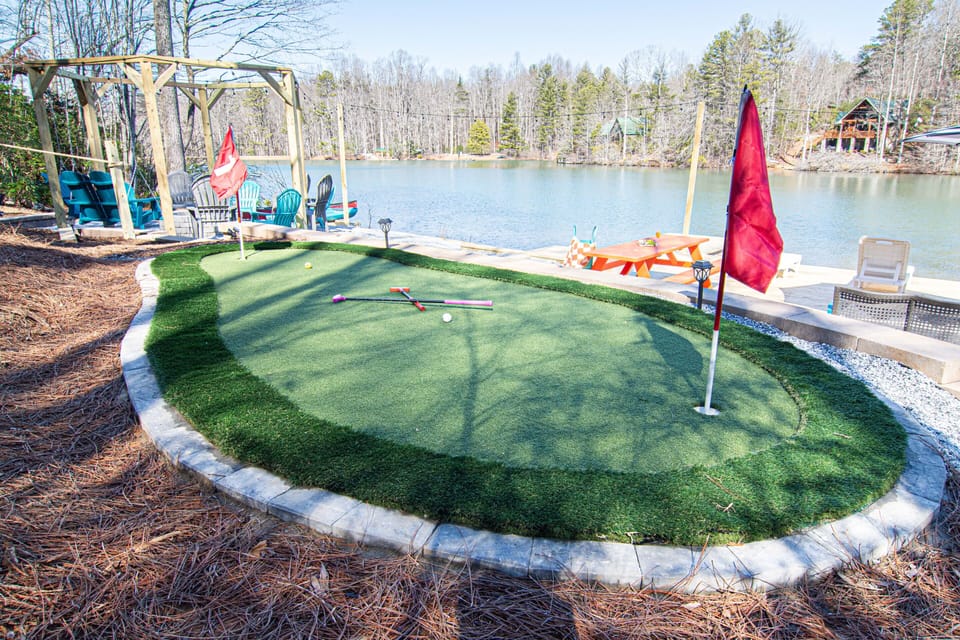 Putt your way to victory on this charming mini-golf green, complete with a lakeside view to enhance the play.